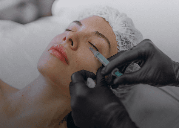 Beauty treatment with syringe and gloves
